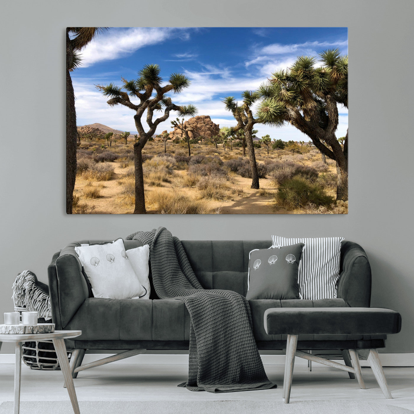 Scenic Joshua Tree landscape with rugged desert terrain, golden dry grass, and a deep blue sky, creating a warm, rustic Southwestern aesthetic.