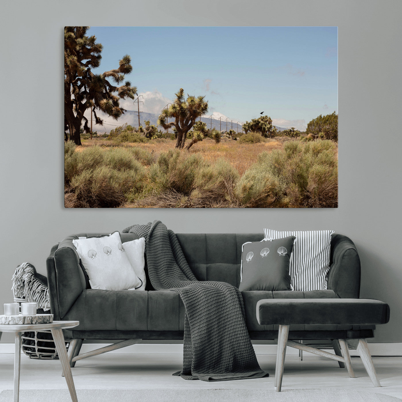 Scenic desert landscape with Joshua trees, dry grass, and distant mountains under a clear blue sky, perfect for southwestern and rustic decor.