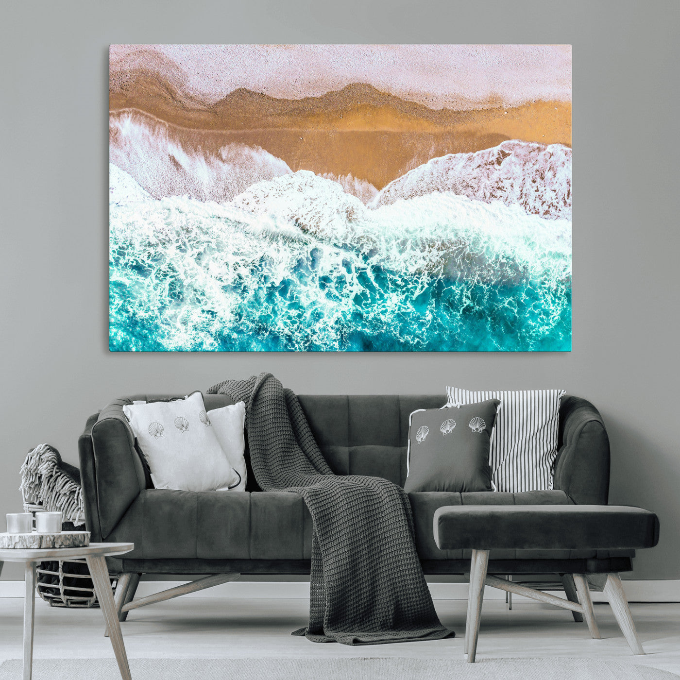 Aerial view of ocean waves crashing onto a sandy beach, with turquoise water and foamy white surf, creating a serene coastal aesthetic for home decor.