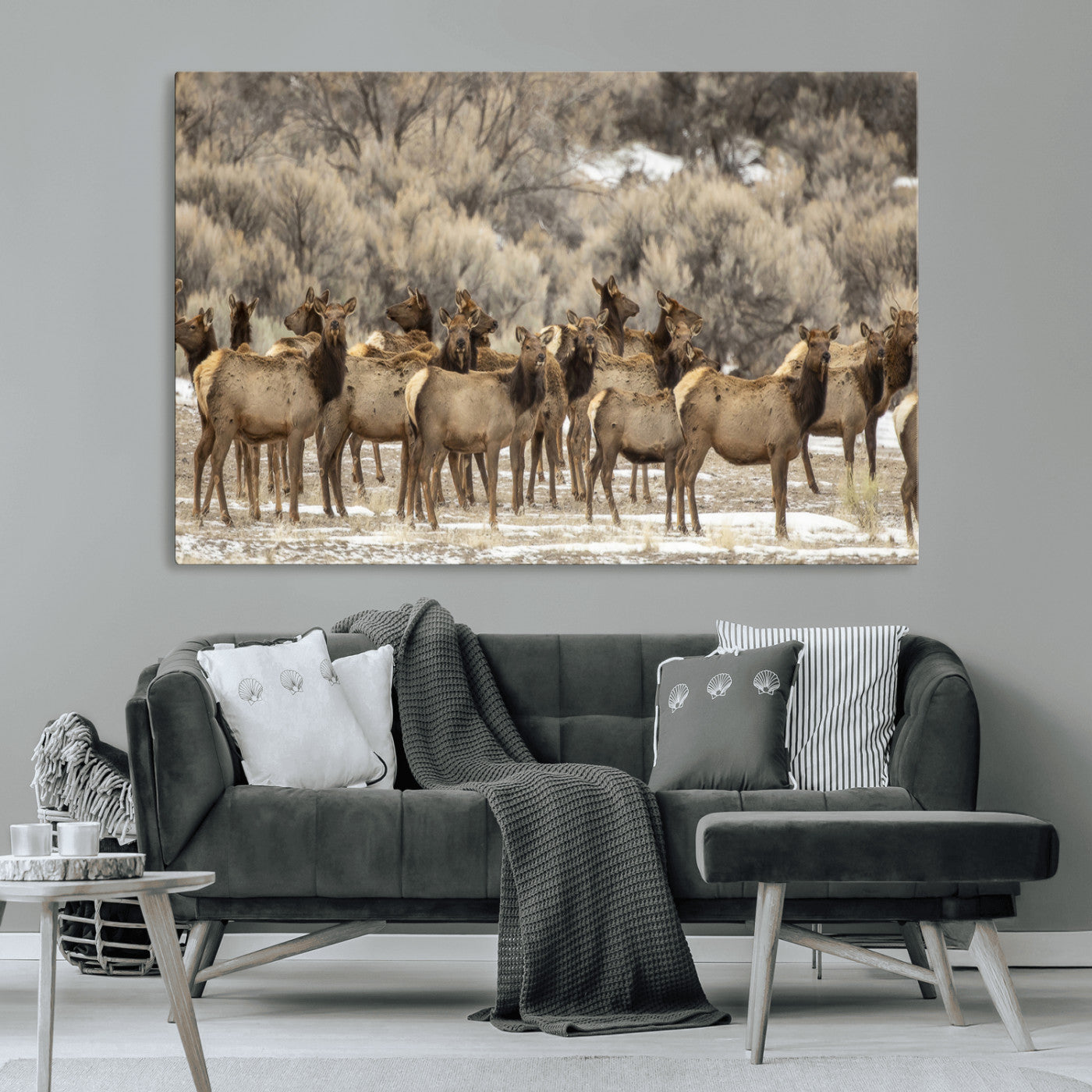 A stunning wall art canvas print featuring a large herd of elk standing together in a natural winter landscape with muted earthy tones and soft background foliage, perfect for rustic or nature-inspired home decor.