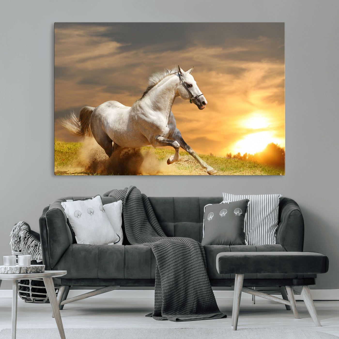 A powerful white horse galloping through the field at sunset, with the golden light illuminating its mane and the vibrant sky in the background.
