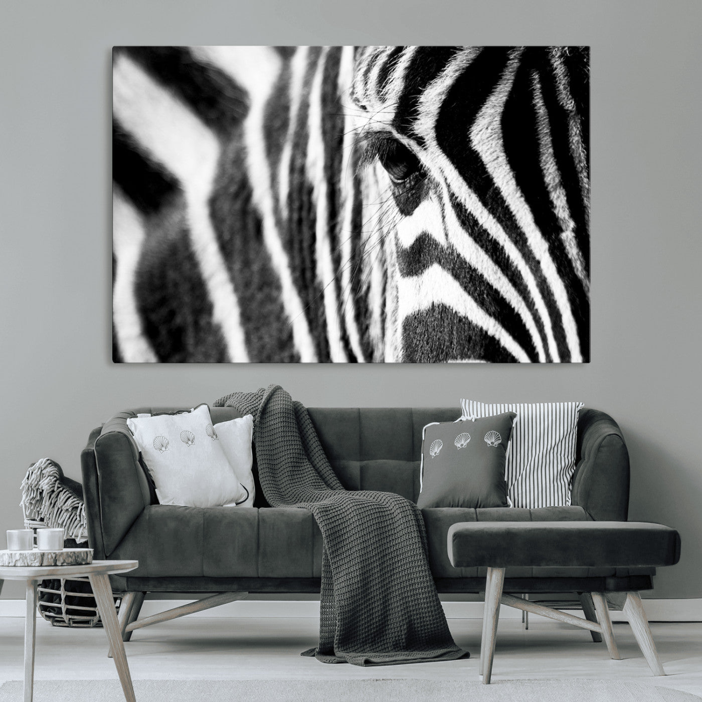 A close-up black and white photograph of a zebra's eye, showcasing the intricate patterns of its stripes in sharp detail.