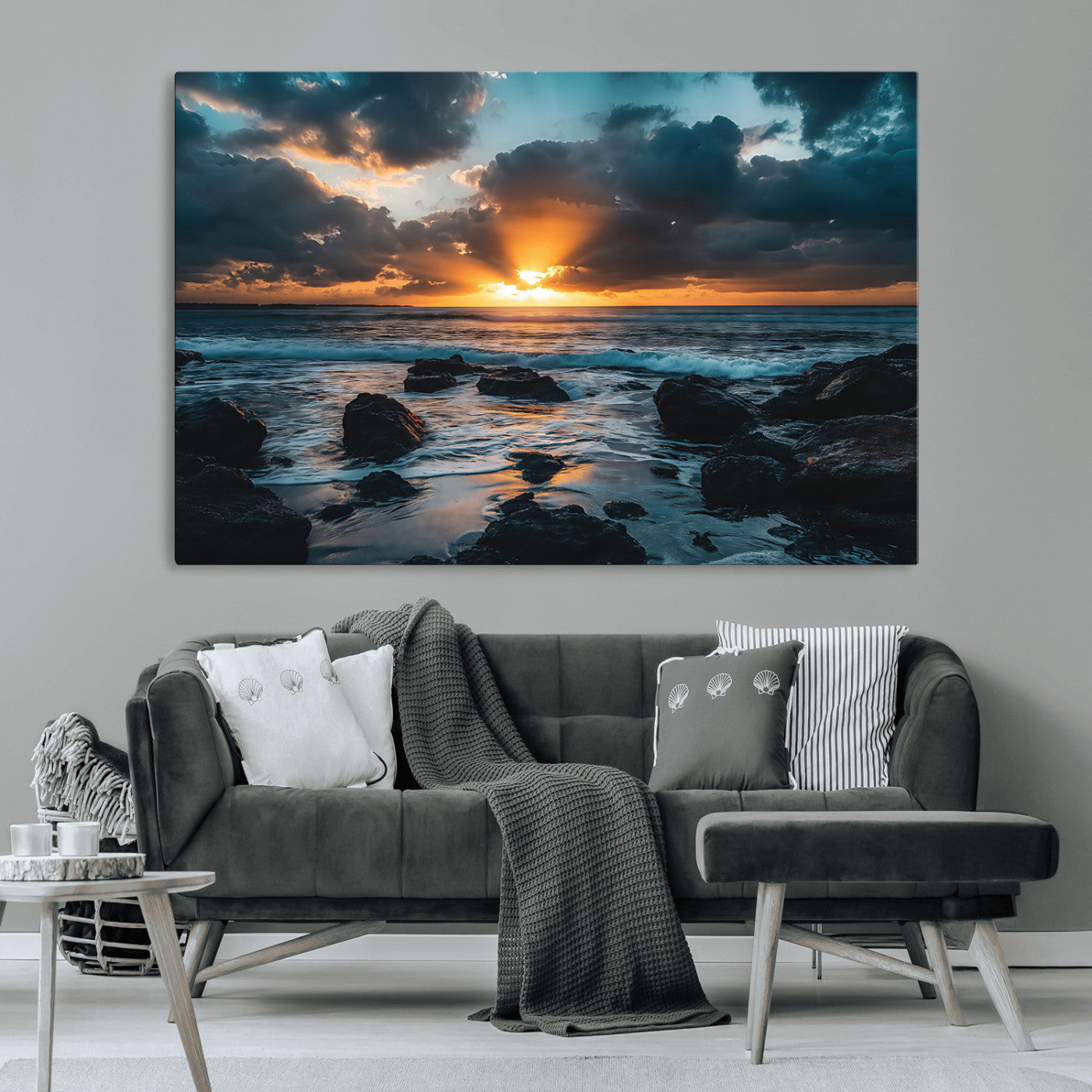 An awe-inspiring sunset over the ocean with rays of light piercing through dramatic clouds, creating a beautiful seascape with rocks in the foreground.