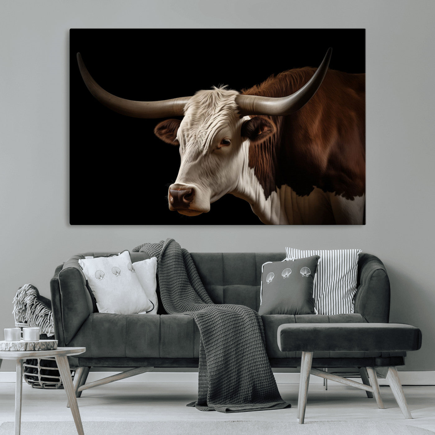 "Close-up of a brown and white longhorn cow with prominent curved horns against a black background."