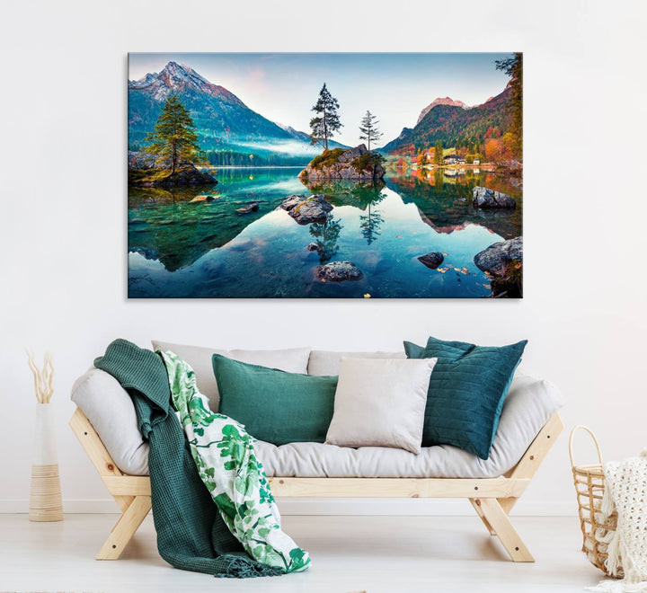 The 3-panel wall art showcases a serene mountain lake with rocky islands and trees, creating an ideal focal point for dining rooms or offices.