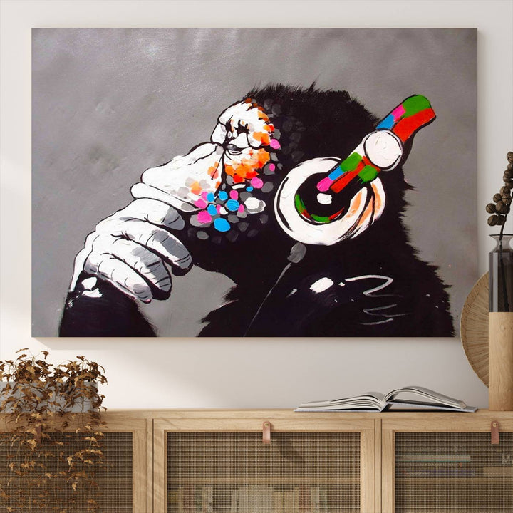 A vibrant triptych, the "DJ Monkey Listening to Music" wall art print, features a Banksy-inspired large canvas adorned with colorful modern pop art. This striking piece elegantly enhances the room with its dynamic and lively depiction.