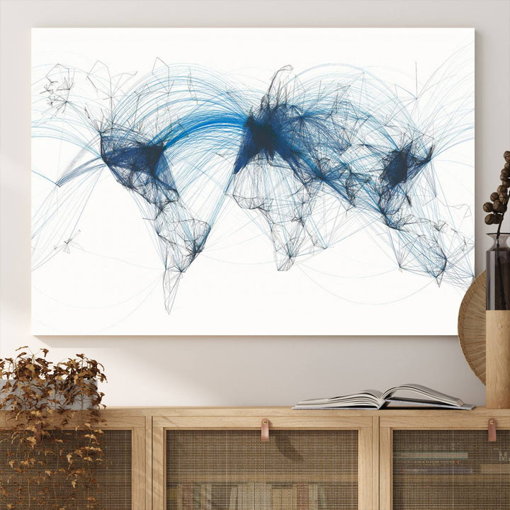 The Aviation Flight Map Wall Art is a set of three abstract panels featuring a world map with blue lines, resembling a flight map. Ideal for aviation enthusiasts, this ready-to-hang framed air traffic art print enhances the appeal of modern decor.