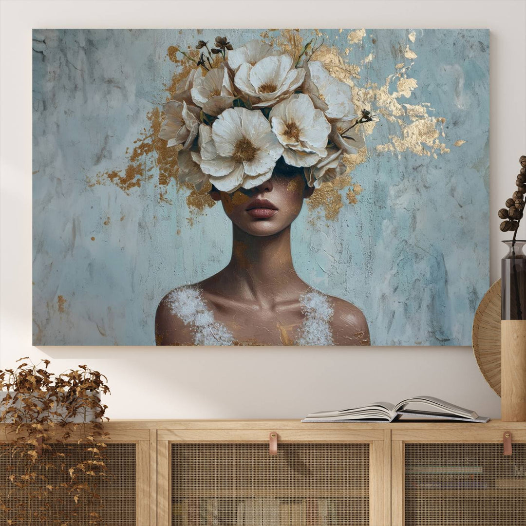 The Golden Petal Silhouette Woman Wall Art Canvas Print, a large 3-panel canvas with a textured gold floral design, serves as a luxurious centerpiece in modern glam settings. The artwork depicts a woman with flowers over her eyes against a textured background and hangs elegantly.