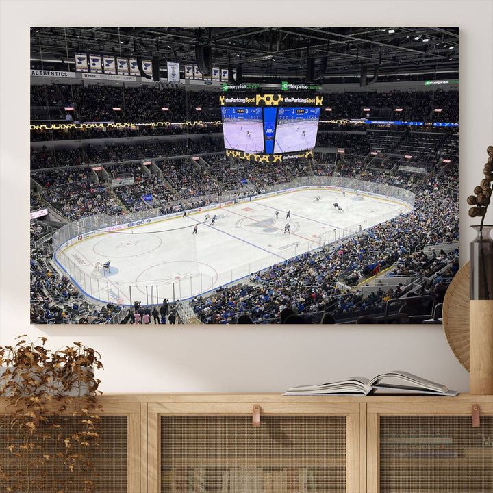 A large Enterprise Center canvas of a crowded hockey arena hangs prominently.