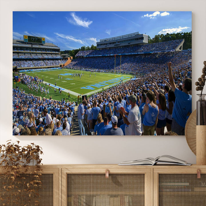 A gallery-quality canvas wall art print featuring the University of North Carolina Tar Heels Football Team and Chapel Hill's Kenan Memorial Stadium adorns the cafe wall.