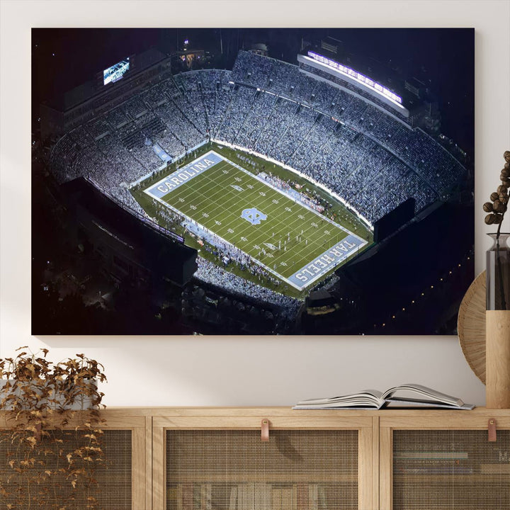 A University of North Carolina Tar Heels Football Team Print, showcasing Chapel Hill's Kenan Memorial Stadium, hangs in a modern dining room, adding a gallery-quality finish that enhances the entire space.