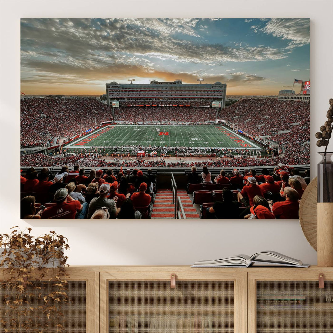 The living room features a stunning triptych of Lincoln Memorial Stadium wall art canvas print, celebrating the University of Nebraska Cornhuskers football team. This piece serves as captivating wall art, showcasing a gallery-quality finish.