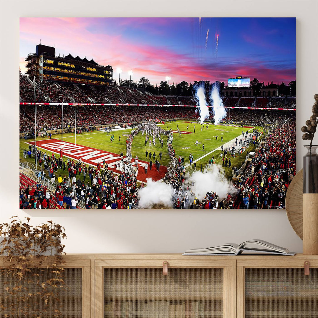 The wall art features a canvas print of the Stanford Cardinal football team, capturing players, fireworks, and smoke against the backdrop of a sunset at Stanford Stadium.