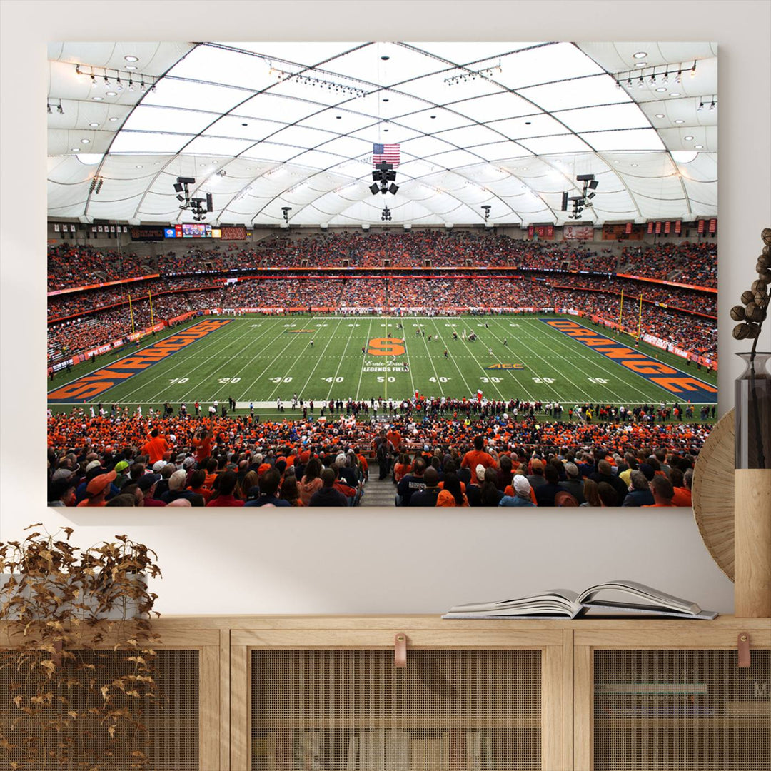 Fans fill the Syracuse JMA Wireless Dome, highlighted in orange and blue under a vaulted roof on this premium canvas print of the scene.