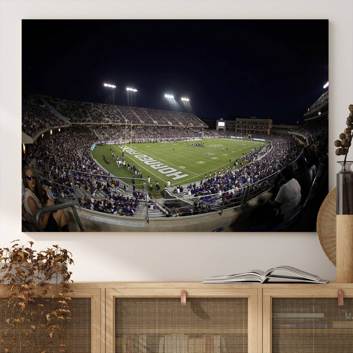 The wall art print features a night view of Amon G. Carter Stadium filled with TCU fans, showcased in the Horned Frogs Football Canvas Wall Art.