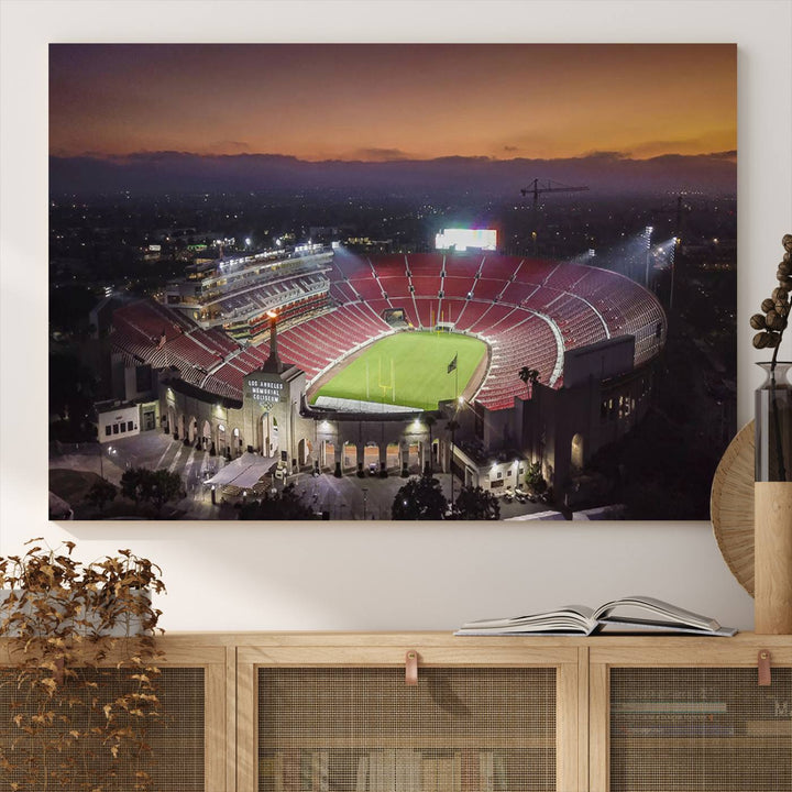 The USC Trojans Stadium canvas captures Memorial Coliseum at twilight, showcasing red seats and a green field beneath an orange sky.