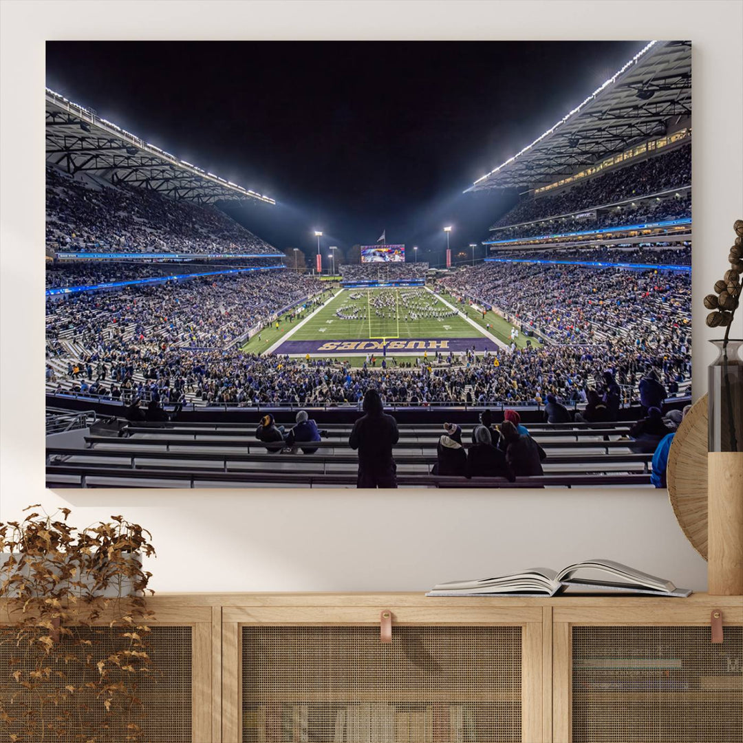 A canvas print titled The University of Washington Huskies Football depicts a packed Husky Stadium at night, as seen from the stands.