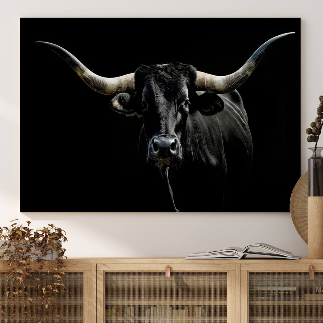 The Texas Black Longhorn Bull Canvas Print, featuring large curved horns set against a dark background, is ideal for Western decor.