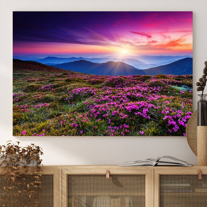 A 3-panel landscape photography canvas of a sunset over mountain meadows with purple wildflowers decorates the wall.