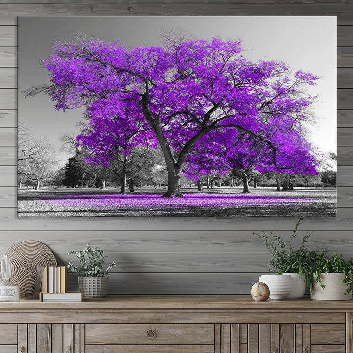 The Big Purple Tree Wall Art Canvas Print showcases a vibrant purple tree set against a black-and-white landscape.