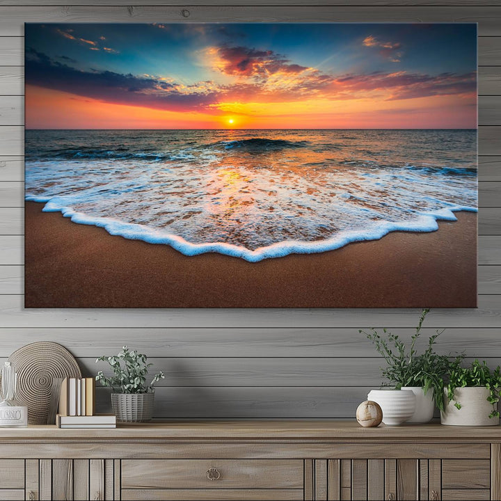 A Sunset with Calm Waves on the Beach Wall Art Canvas Print adorns the dining room.