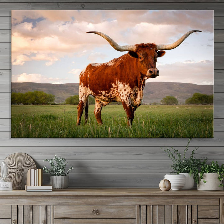 The Texas Cow Canvas Wall Art print captures a longhorn cow at sunset and is ready to hang.