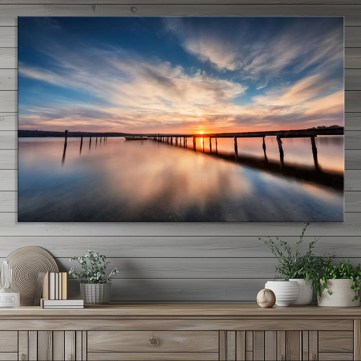 The Sunset Pier Canvas features a serene coastal landscape with vibrant hues under cloudy skies, ideal for modern decor.