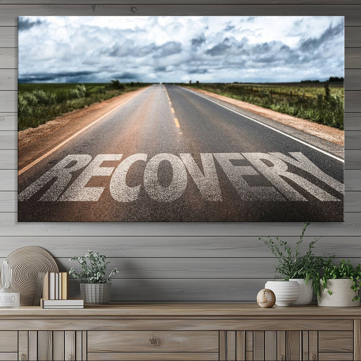 The Recovery Road Wall Art Canvas Print depicts a road under a cloudy horizon.