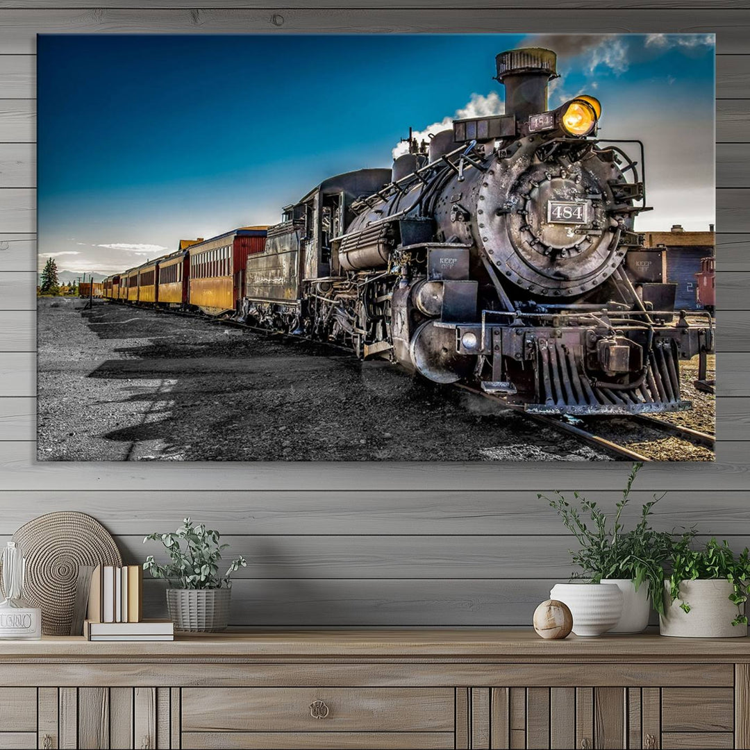 The Train Wall Art Canvas Print features a vintage steam train with a bright headlight.