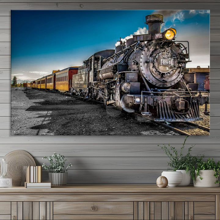 The Train Wall Art Canvas Print features a vintage steam train with a bright headlight.