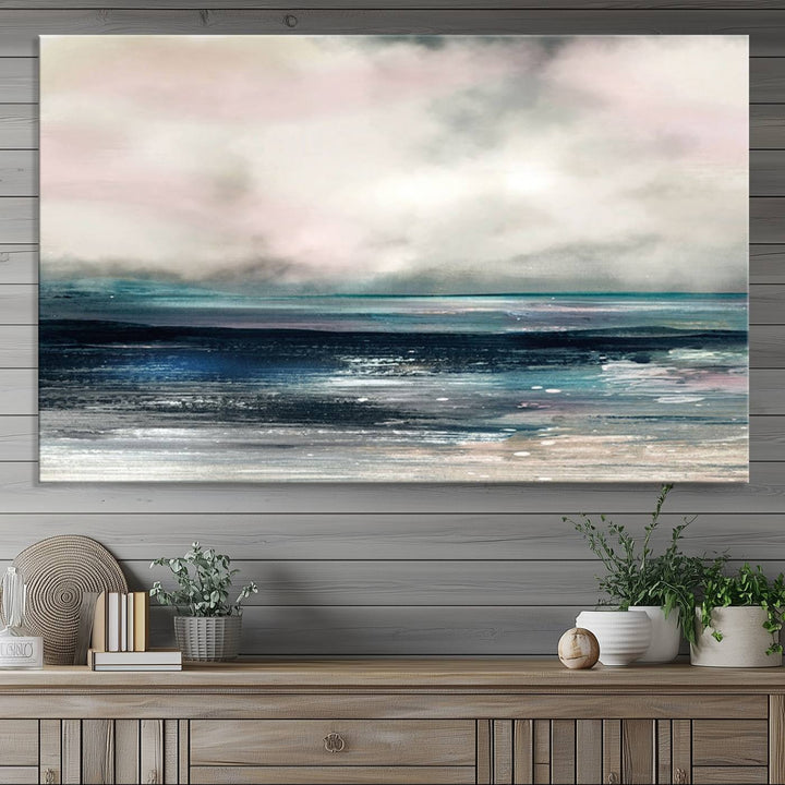 A contemporary abstract wall art canvas print in pastel pink, teal, and gray tones hangs on the wall.