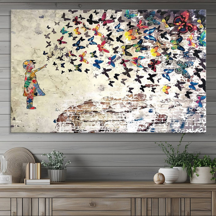 A Banksy Girl Butterfly Canvas Print is displayed on the textured wall.