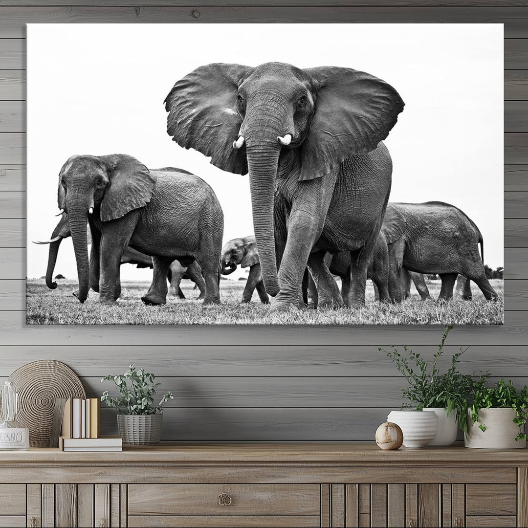 A modern dining area features a Black White Elephant Family Wall Art Canvas Print.