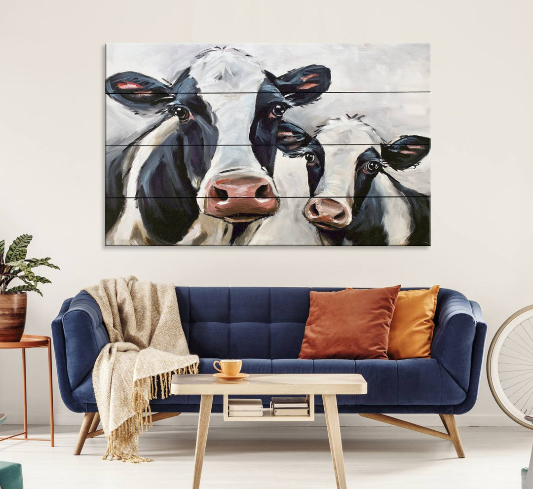 The Vintage Baby and Mom Cattle Canvas, featuring cows with black and white patches, is a prominent piece of wall art.