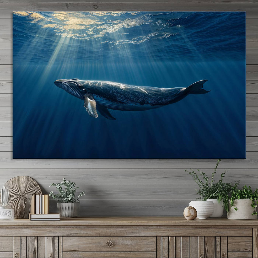 The Whale under Ocean wall art canvas print graces the white wall.