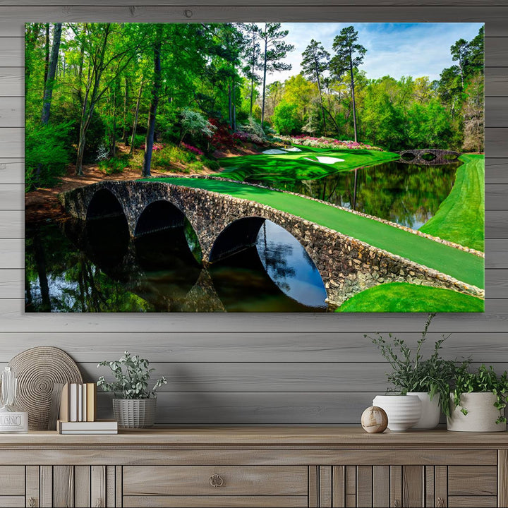 The wall art from Augusta National Golf Club showcases a panoramic bridge set against rich, lush greenery on a framed triptych canvas.