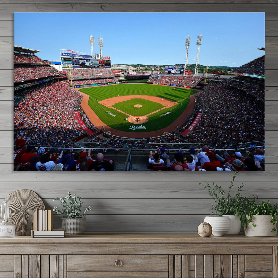 The Cincinnati Reds Baseball Team print of Great American Ball Park Stadium adorns the wall.