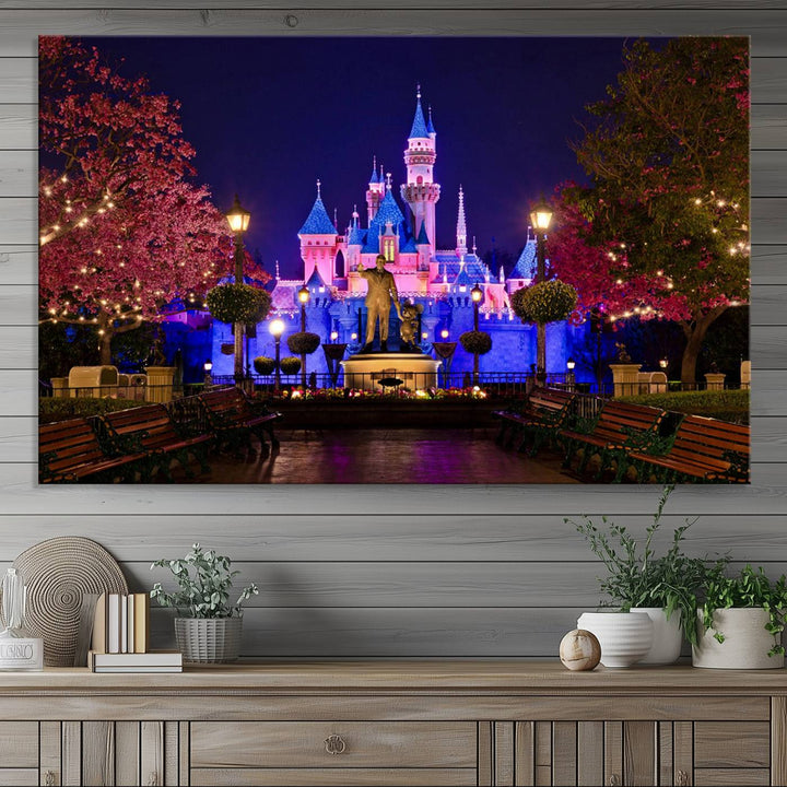 The Castle Large Wall Art is surrounded by illuminated trees at night.