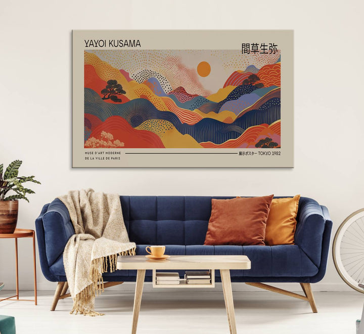 The Yayoi Kusama vibrant landscape canvas print featuring abstract mountains and a sun enhances the space with its modern aesthetic.