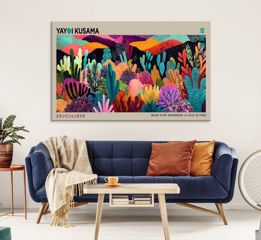 The framed Yayoi Kusama wall art adds vibrancy above the blue couch.