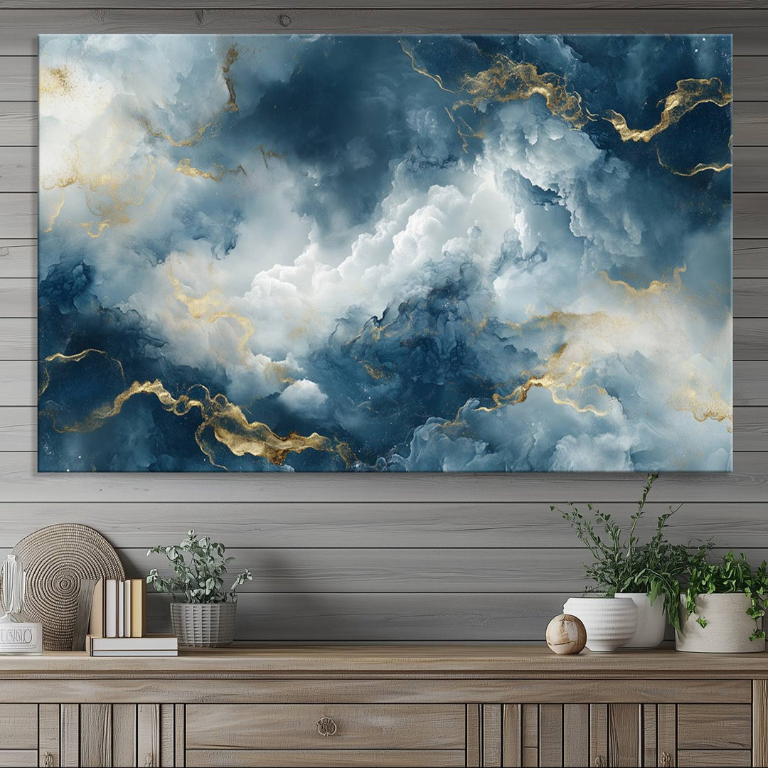 Modern living room featuring the Large Abstract Print - Luxe Blue and Gold Abstract Canvas Wall Art that showcases a bold cloudscape, perfect for modern home decor.