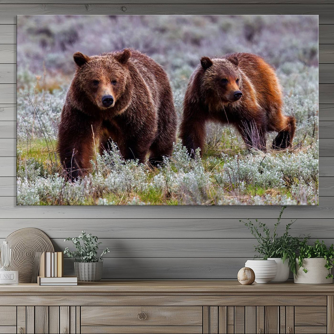 The "Queen of the Tetons" is a stunning canvas art print featuring Grizzly 399 and two bears strolling through a grassy field. Its gallery-quality finish beautifully captures the essence of nature, making it perfect for rustic home decor.