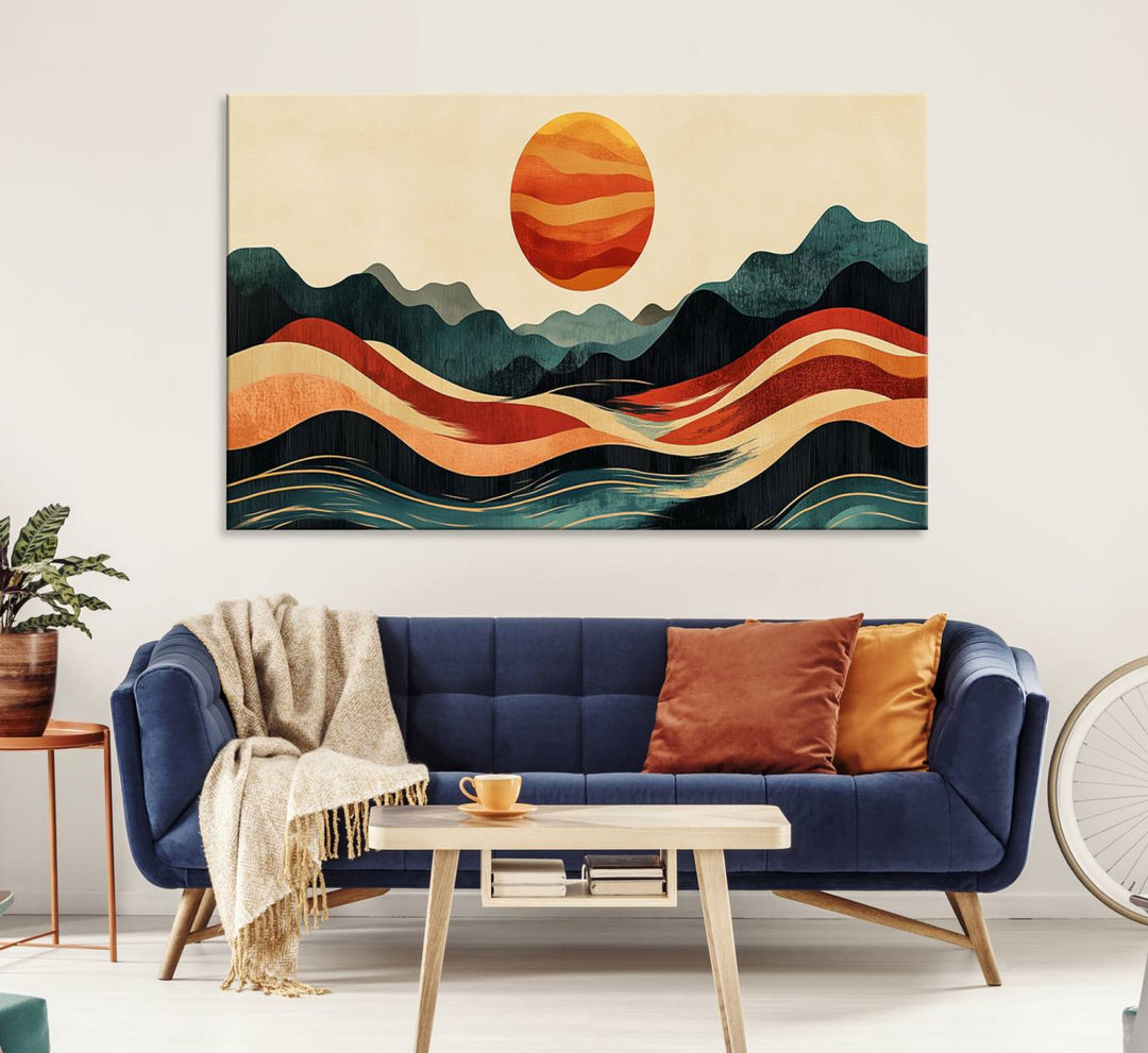 The Mountain Triptych wall art, featuring a design of the sun, mountains, and waves, is displayed prominently on the wall.