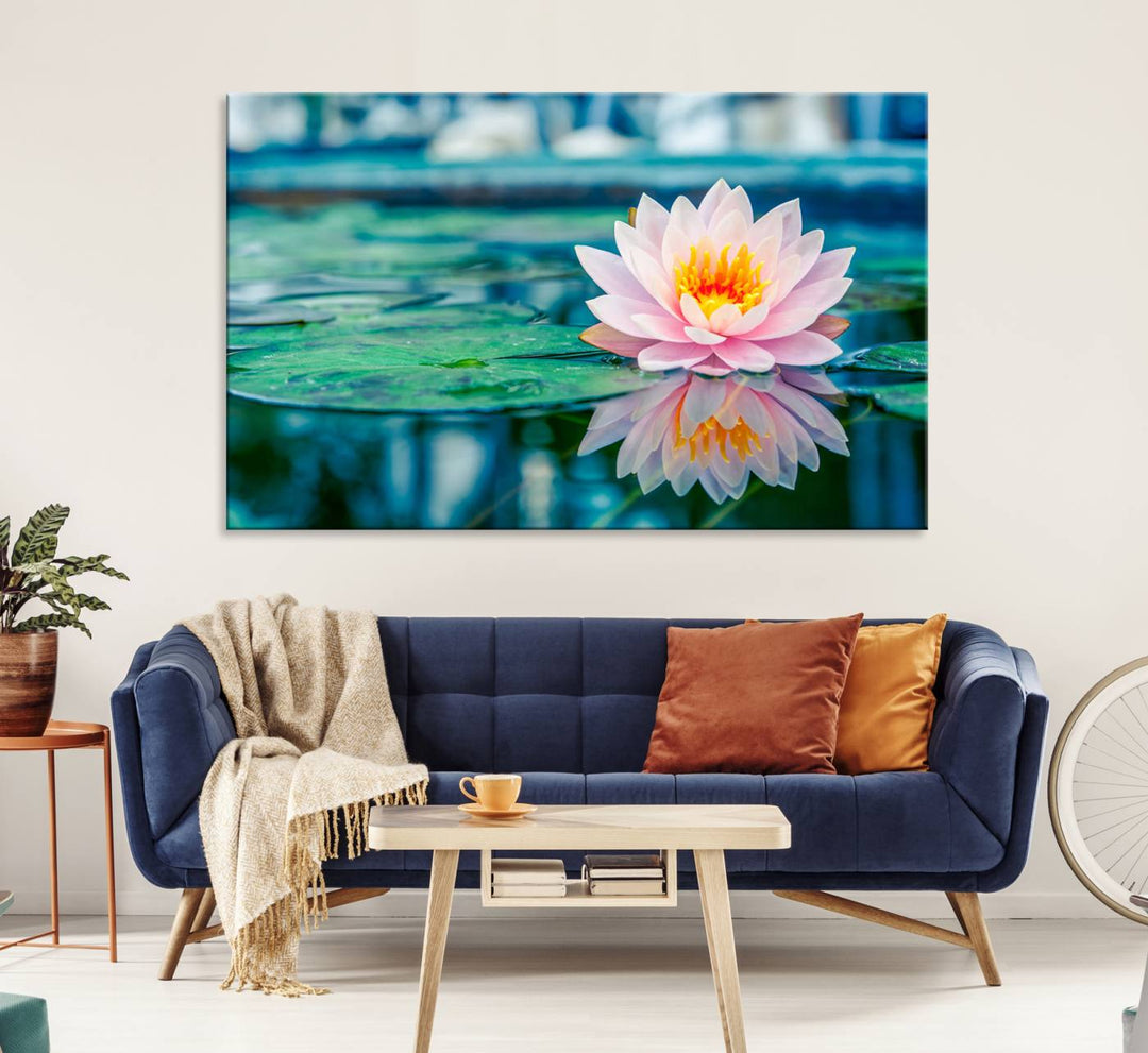 The Lotus Flower Canvas Print showcases a pink water lily with a yellow center gracefully floating on a calm pond.