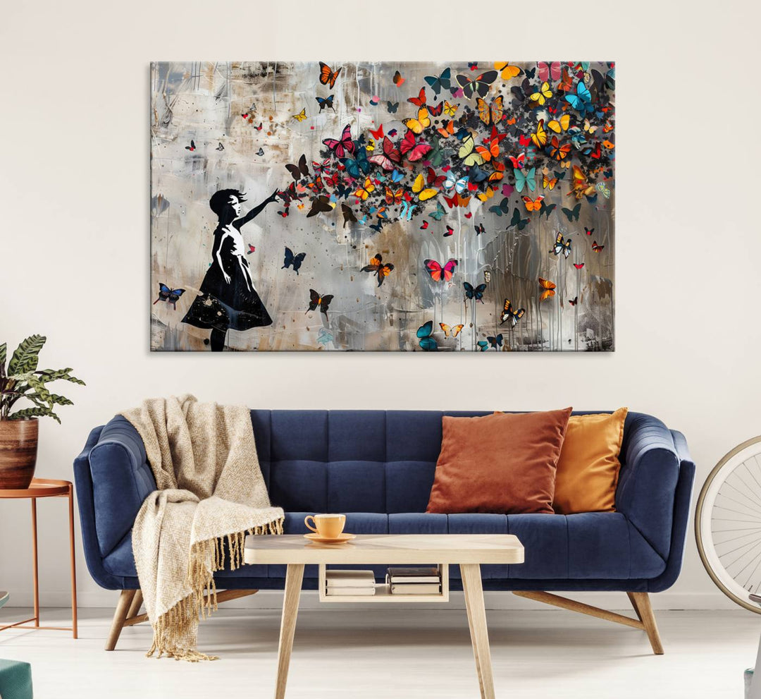 The Banksy Butterfly Girl 3-Piece Modern Graffiti Canvas Wall Art features a silhouette of a girl reaching for butterflies.