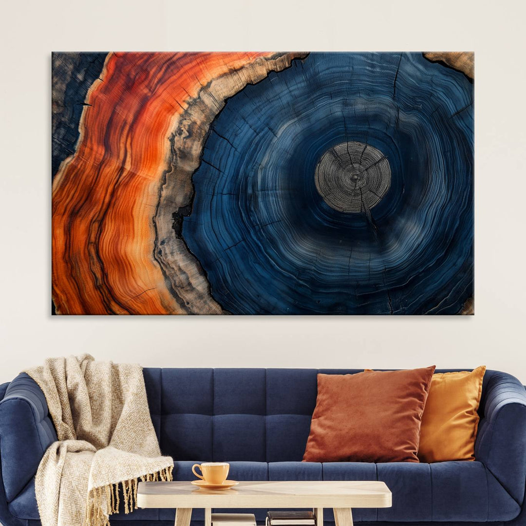 Abstract Tree Ring Wall Art Print on canvas featuring vibrant blue, orange, and brown rings with a natural rustic wood texture. Free shipping available!.