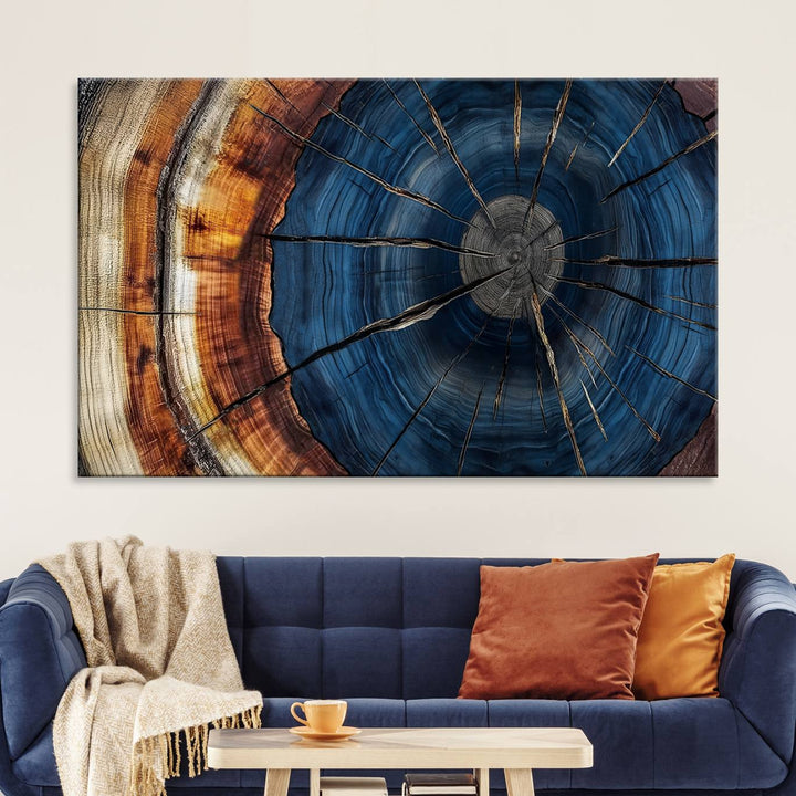 The Abstract Tree Rings Canvas Print features blue, brown, and orange rings that highlight wood grain and natures beauty.