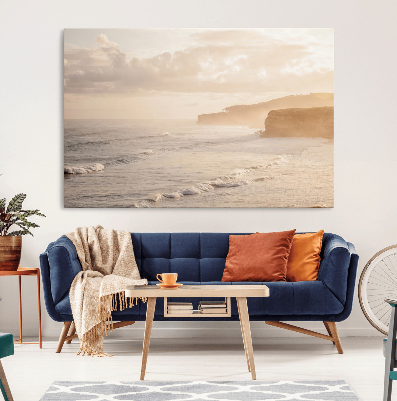 Golden hour seascape with misty cliffs and gentle waves rolling towards the shore, capturing a tranquil and warm coastal atmosphere.