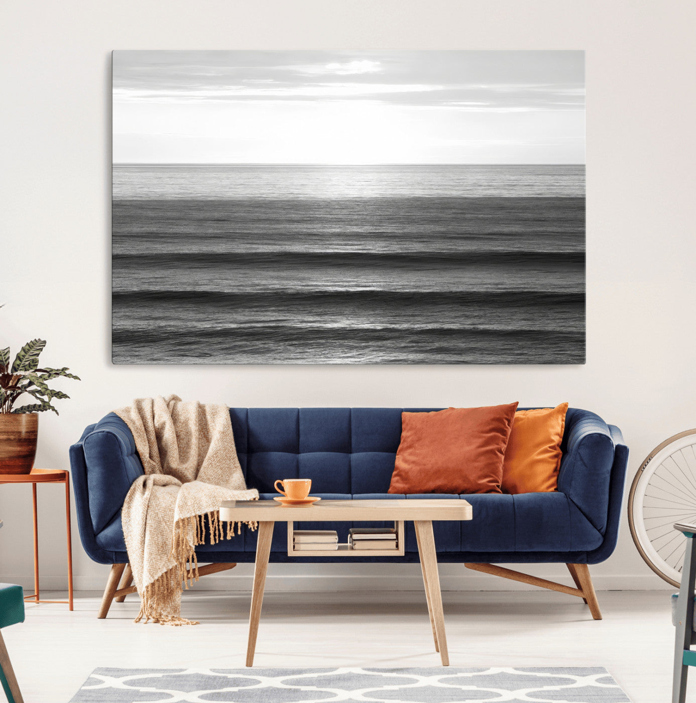 Minimalist black and white ocean view with layered waves reflecting sunlight, evoking a sense of calm and coastal serenity.