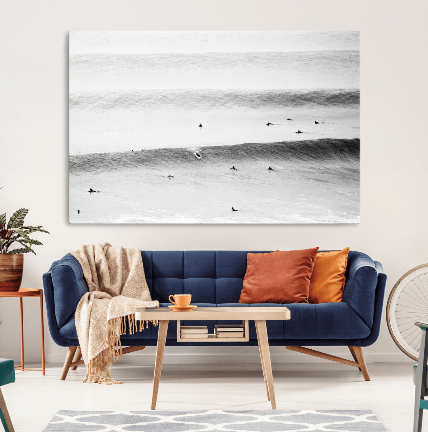 A monochrome photograph of swimmers gliding through gentle ocean waves, evoking a sense of calm and movement.
